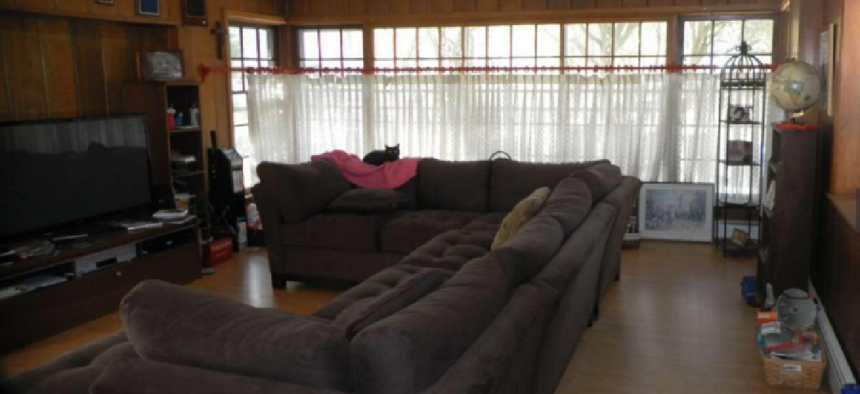 Part of the slideshow for prospective buyers of Philadelphia District Attorney Seth Williams' house includes this photo of his living room with a $3,200 custom-made chocolate couch that is at the center of a federal investigation.
