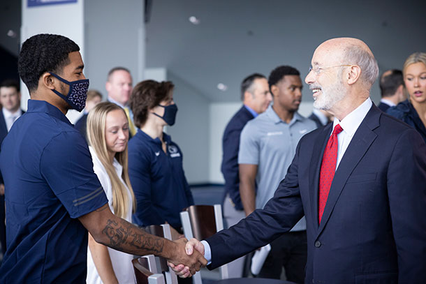 Gov. Tom Wolf joins Penn State athletes to celebrate NIL legislation being passed last year.