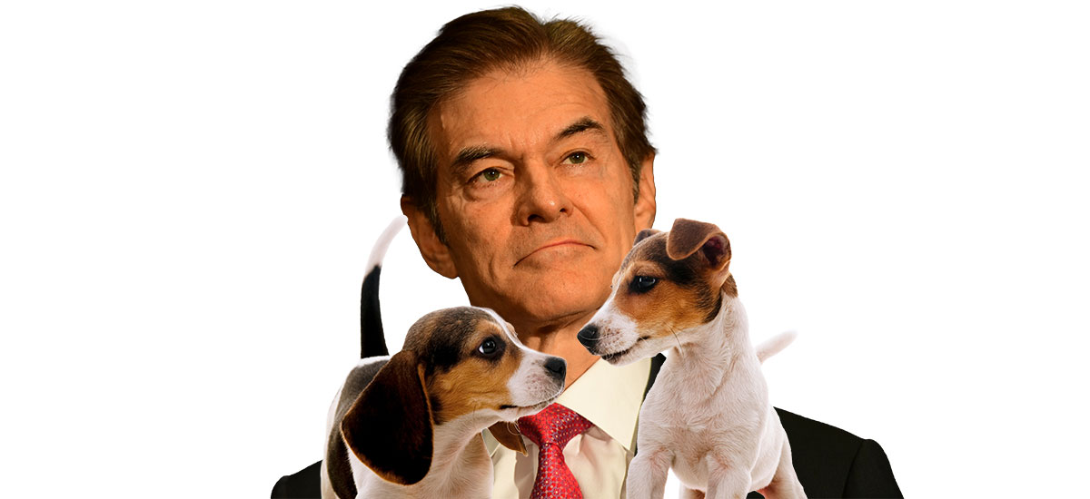 Dr. Mehmet Oz and two puppies
