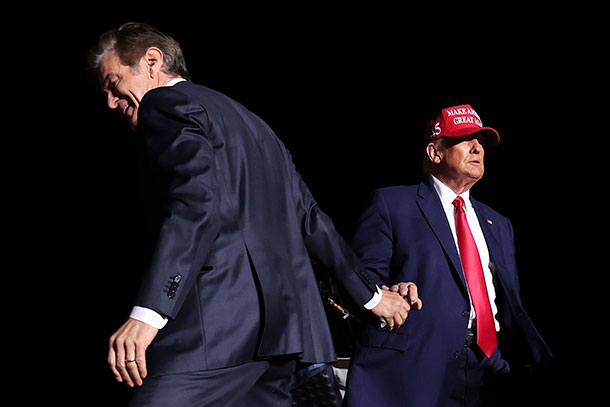 Dr. Mehmet Oz shakes hands with former President Donald Trump during a rally in Latrobe in early November.