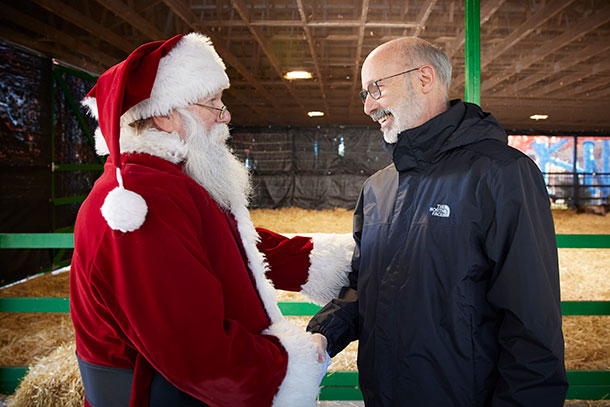 Gov. Tom Wolf shakes Santa Claus' hand in December 2021.