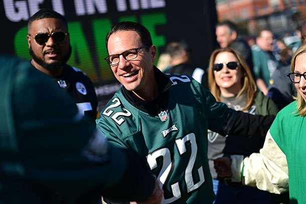 Shapiro and running mate Austin Davis (left) tailgate with supporters at an Eagles game on Oct. 30, 2022.