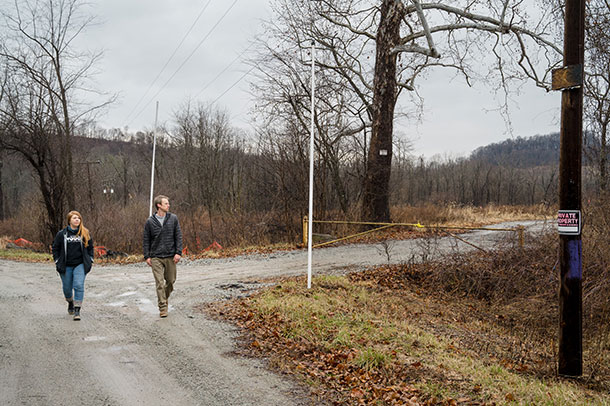 Stacey Magda and Eric Harder walk along MillBell Road, nearby the active hazardous waste landfill owned by MAX.