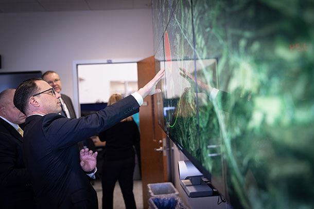 Gov. Josh Shapiro consults a map with emergency management officials from the PEMA media center.