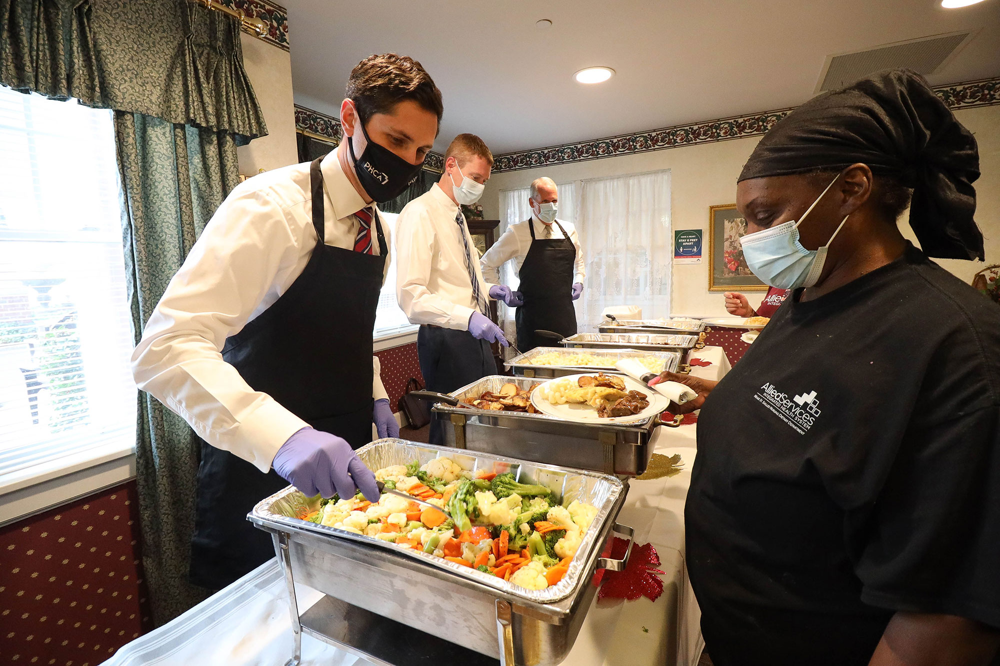 Shamberg and others from PHCA volunteer serving meals to health care workers.