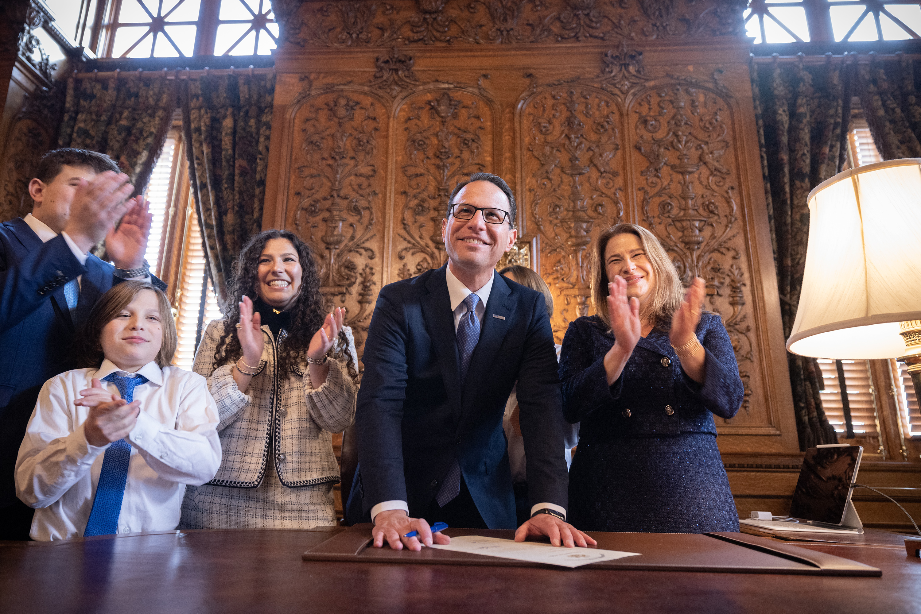 Gov. Josh Shapiro, and his family, sign the official documents of office.