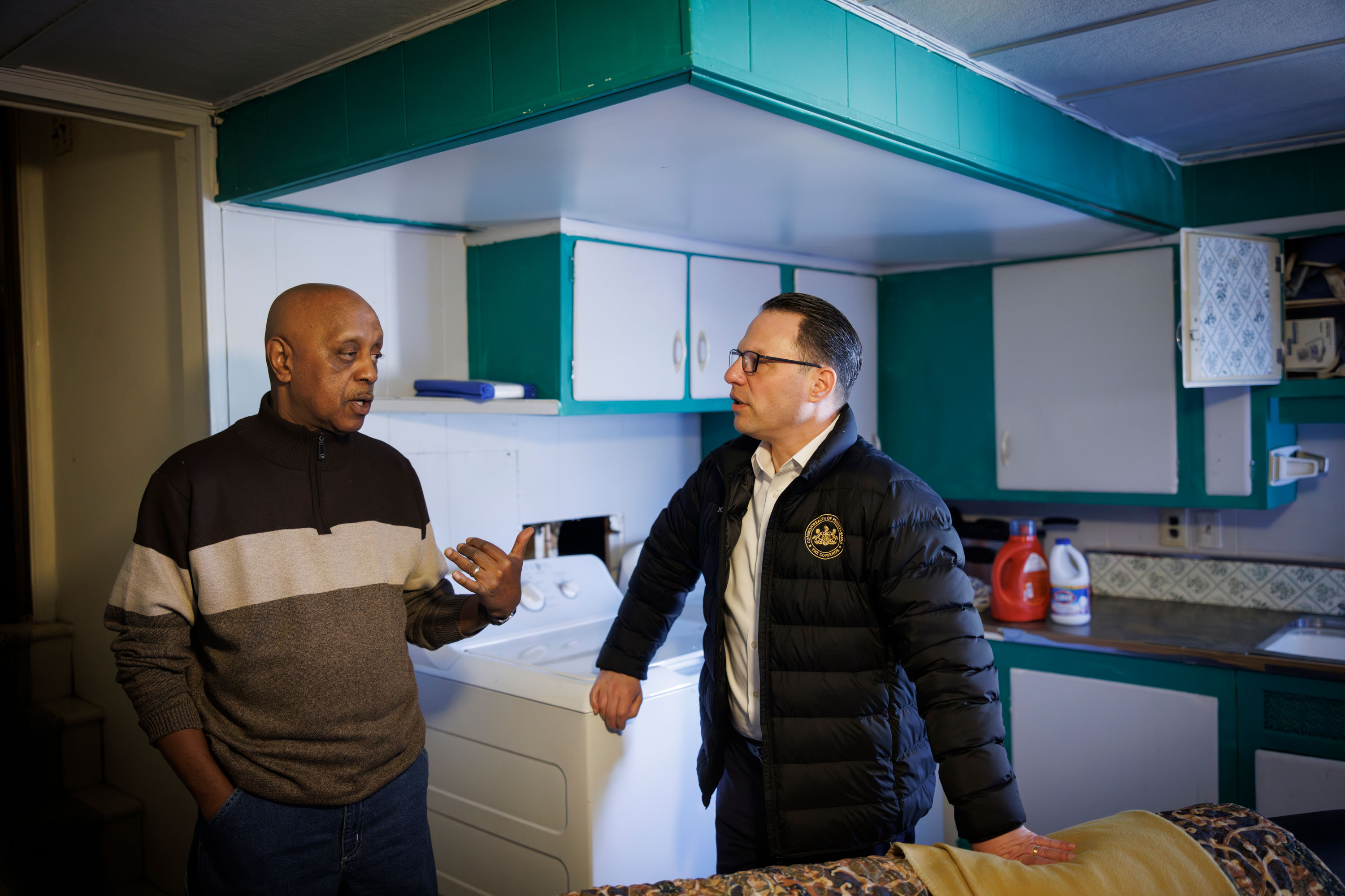 Gov. Josh Shapiro speaks with a homeowner in Dauphin County.