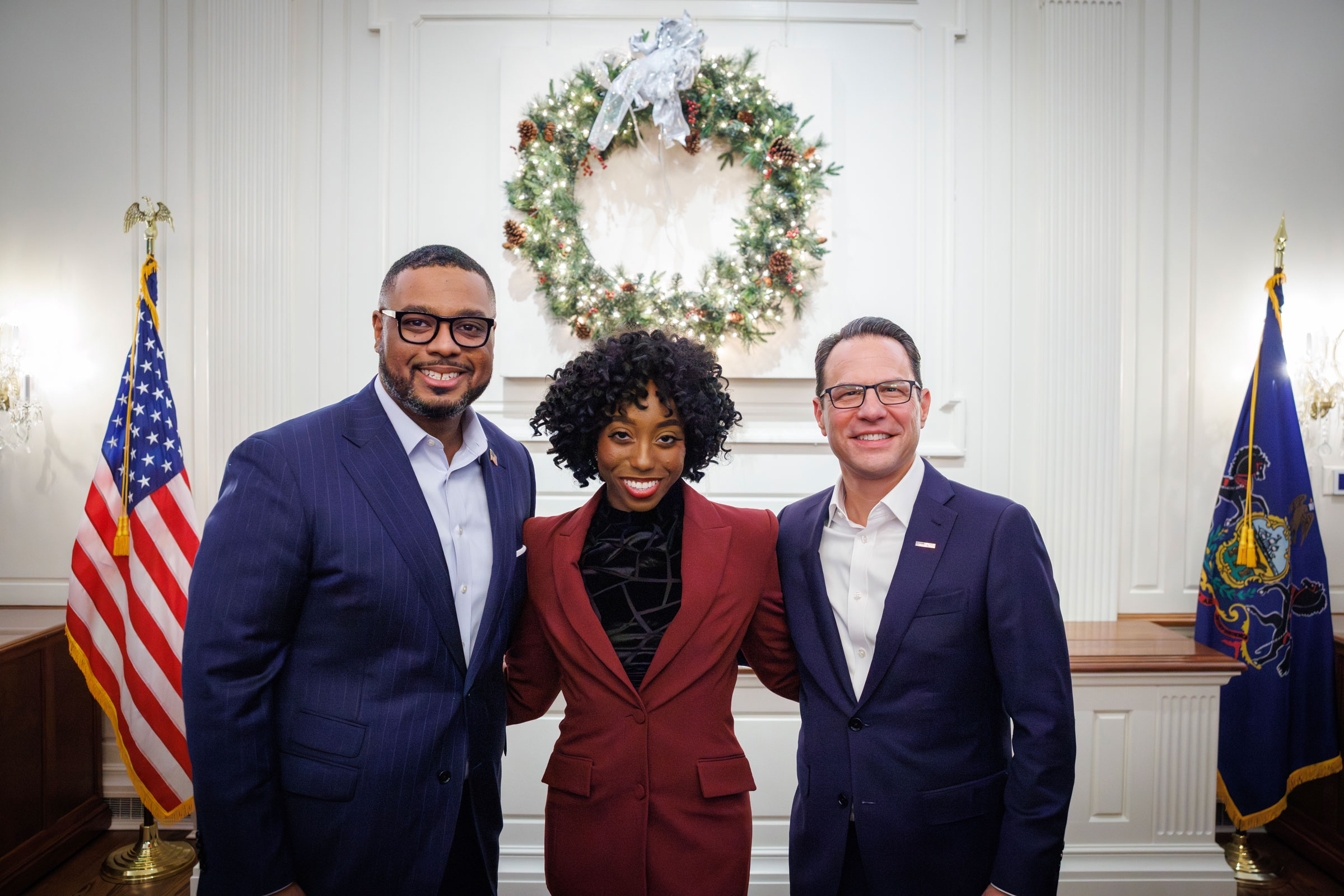 Influencer Tynecia Wilson, flanked by Lt. Gov. Austin Davis and Gov. Josh Shapiro.
