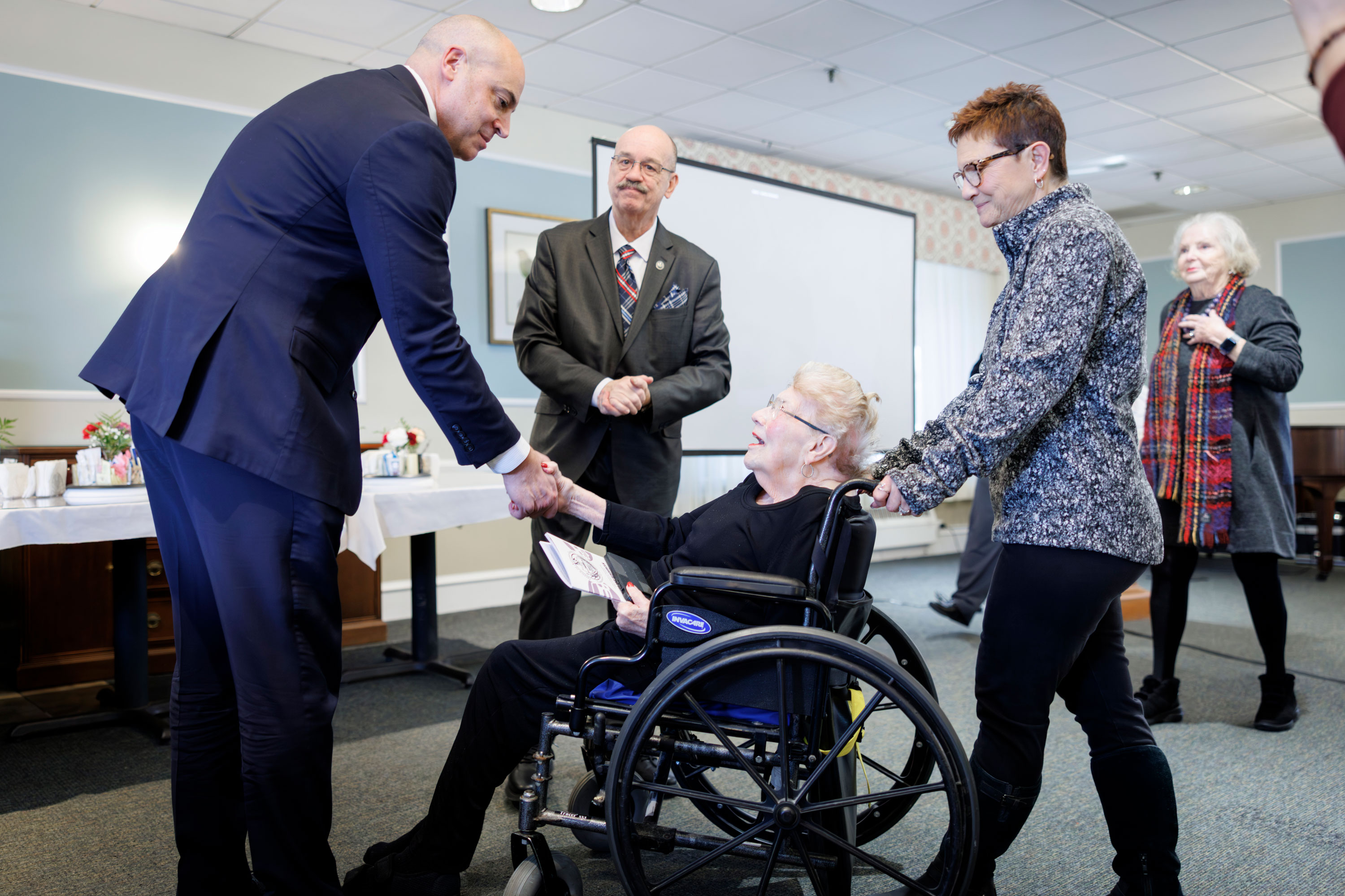 Attorney General Dave Sunday shakes hands with Betty Hungerford at an identity theft awareness event in January.