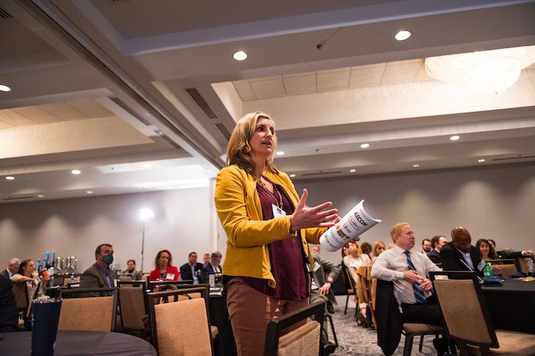 An audience member speaks to panelists