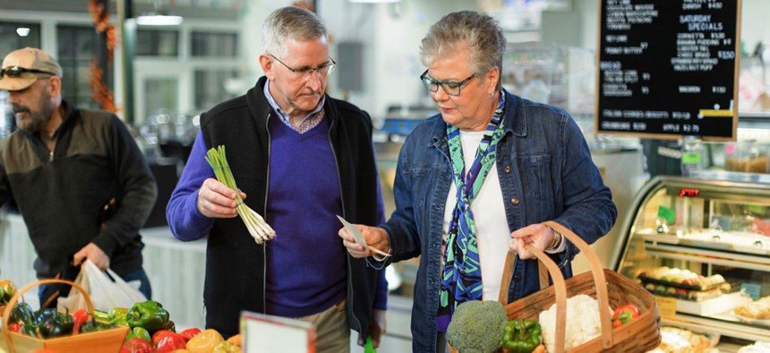 Agriculture Secretary Russell Redding and First Lady of Agriculture Nina Redding grab locally grown vegetables from Dennis Fitz Produce inside York Central Market House on Thursday, November 17, 2022.