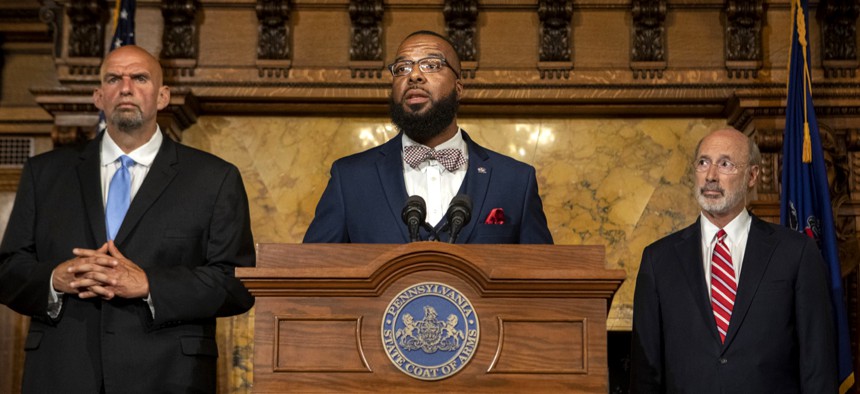 Gov. Tom Wolf, right, implemented two marijuana expungement programs.