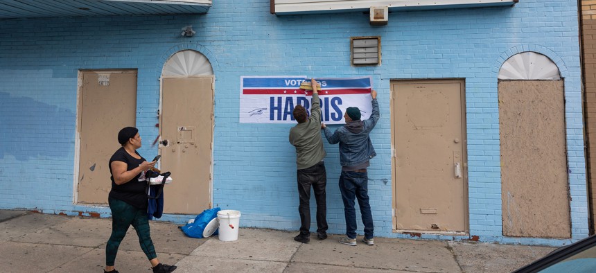 Supporters put up Spanish signs in support of Vice President Kamala Harris in October.