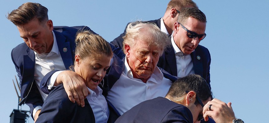 Then-candidate (now President-elect) Donald Trump is rushed offstage during a rally on July 13, 2024 in Butler, Pennsylvania.