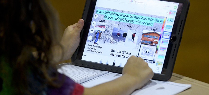 A student does her school work on an iPad at the Mulberry Street location of the Olivet Boys and Girls Club in Reading in 2021.