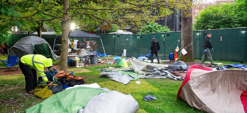 Maintenance staff and waste disposal crews clean up after police cleared a pro-Palestinian protest encampment on the campus of the University of Pennsylvania in Philadelphia, Pennsylvania on May 10, 2024.