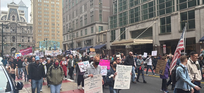With Philadelphia City Hall in the background, protesters fill Market Street on their way to Independence Mall at the "Hands Off" event.