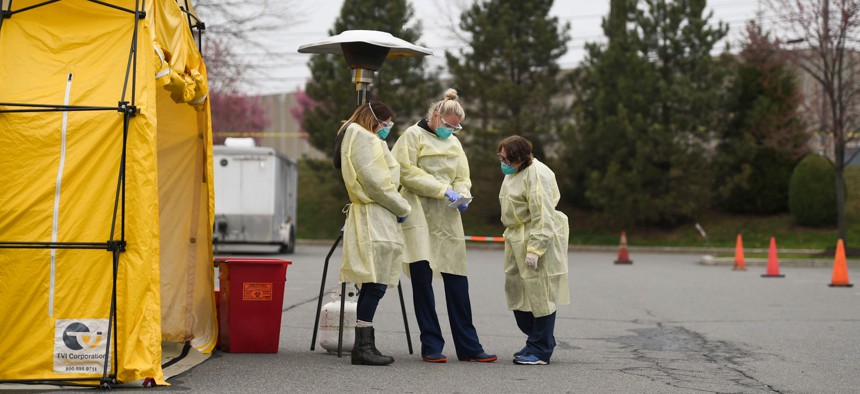 (L-R) Nurses Kimberly Weigand, Kristen Gaumer and Debbie Jessell man the Drive Up Testing tent Thursday, March 19, 2020, at Penn State Health St. Joseph in Bern Township. A nursing shortage during the pandemic led to major reforms in Pennsylvania.